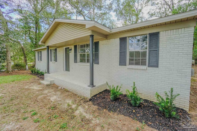 view of side of home with covered porch