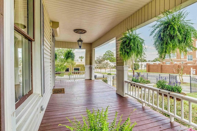 wooden terrace with fence and a porch