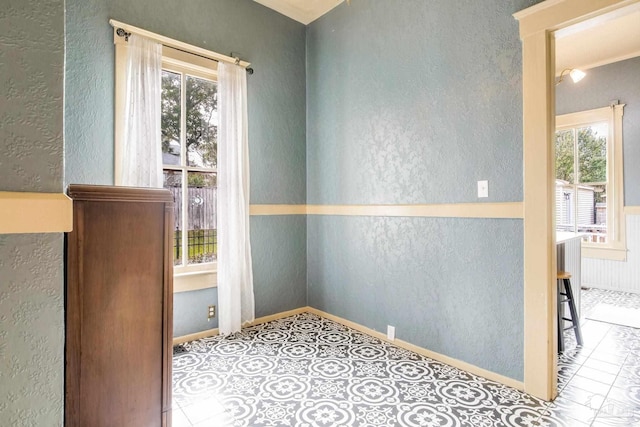 interior space with baseboards and a textured wall