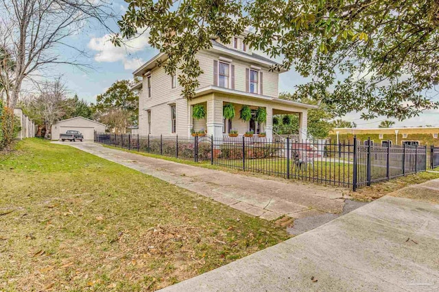 traditional style home featuring a fenced front yard, a front yard, an outdoor structure, and a garage