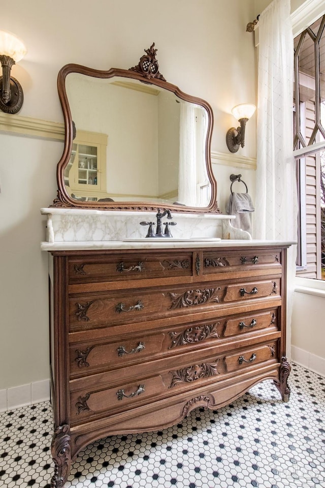 bathroom with tile patterned flooring, vanity, and baseboards