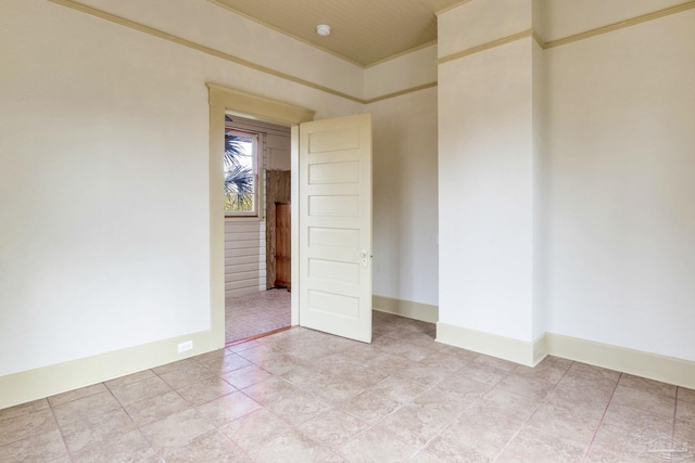 unfurnished room featuring baseboards