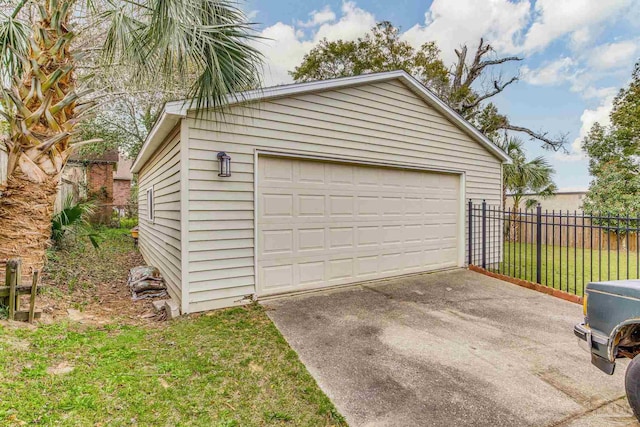 detached garage featuring fence