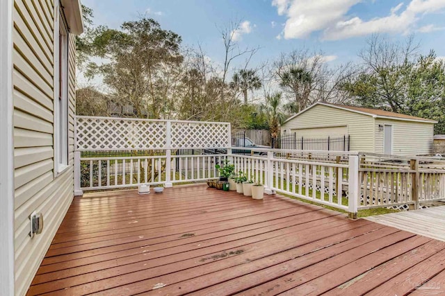 deck featuring fence and an outdoor structure