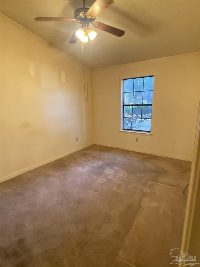 carpeted spare room with ceiling fan