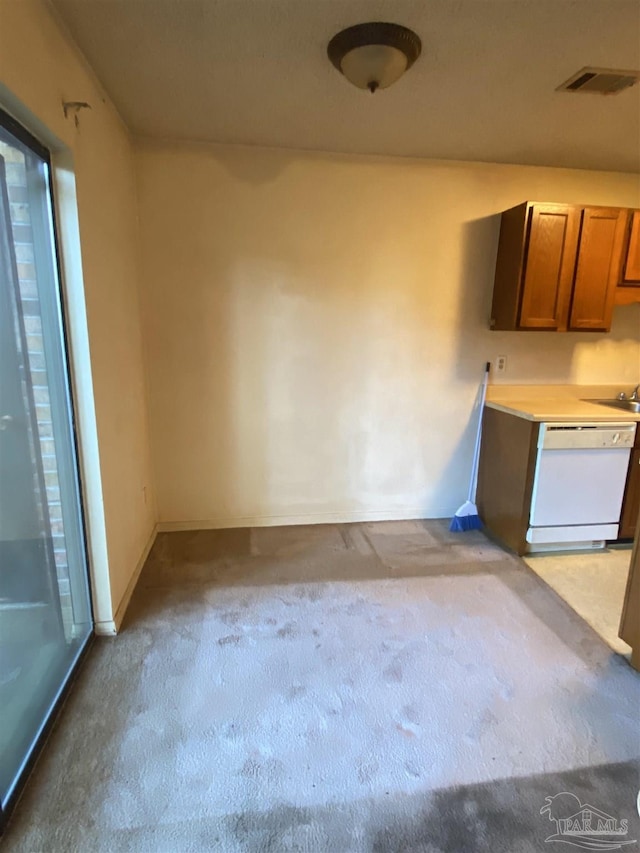 kitchen with dishwasher, light colored carpet, and sink