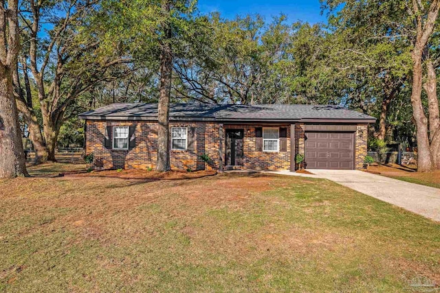 single story home featuring an attached garage, brick siding, fence, driveway, and a front lawn