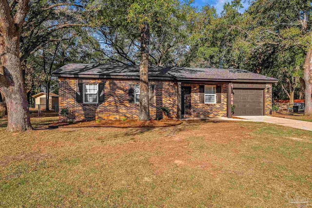 single story home with concrete driveway, brick siding, an attached garage, and a front yard