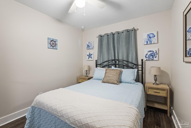 bedroom with ceiling fan, dark hardwood / wood-style floors, and a textured ceiling