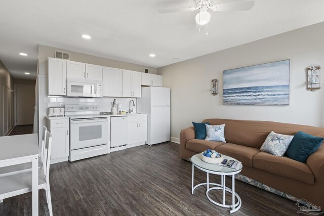 kitchen featuring sink, white appliances, dark hardwood / wood-style floors, tasteful backsplash, and white cabinets