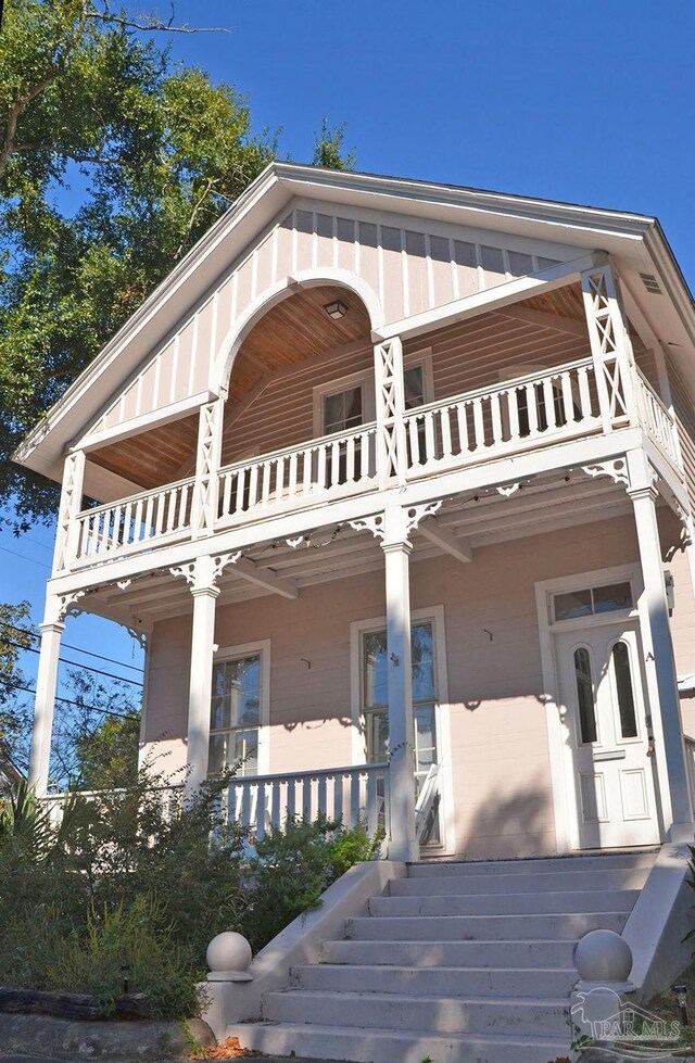 view of front facade featuring a balcony and covered porch