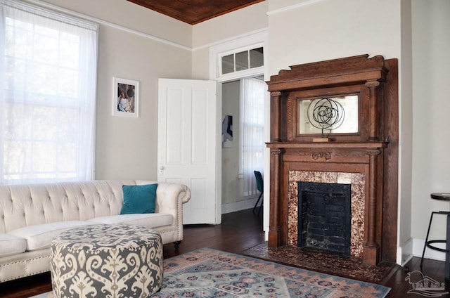 living room with wood ceiling, baseboards, dark wood-style flooring, and a tile fireplace