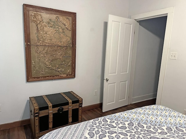 bedroom featuring dark wood-type flooring and baseboards