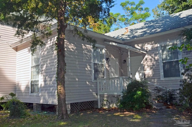 view of property exterior with a shingled roof