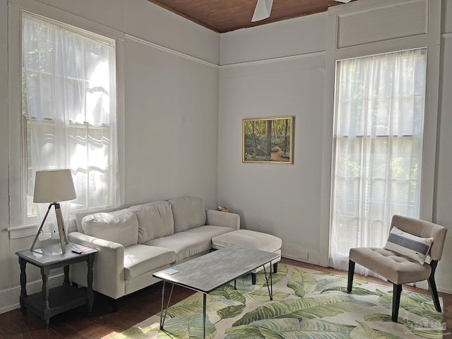 living room with wood finished floors, wood ceiling, and baseboards