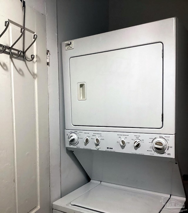 laundry room featuring stacked washer / dryer and laundry area