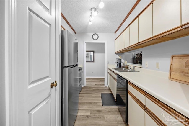 kitchen featuring stainless steel refrigerator, sink, black dishwasher, a textured ceiling, and light wood-type flooring