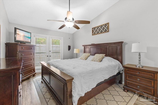 bedroom featuring french doors, access to outside, vaulted ceiling, ceiling fan, and light hardwood / wood-style flooring