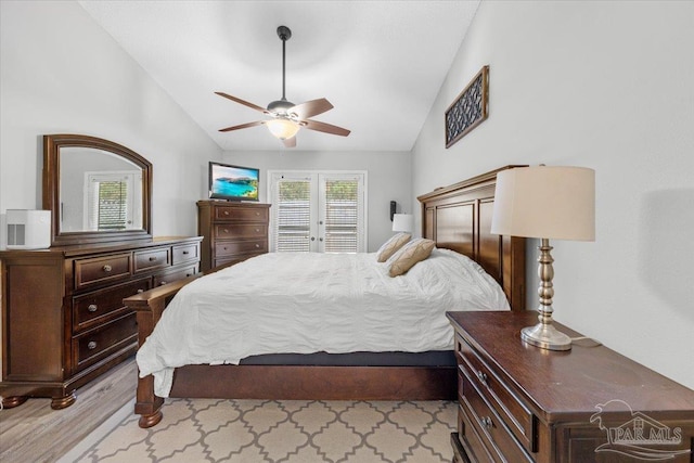 bedroom featuring ceiling fan, light hardwood / wood-style floors, and lofted ceiling