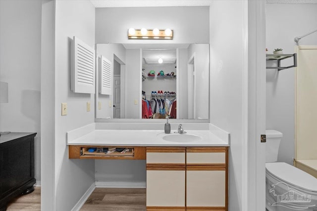 bathroom with vanity, hardwood / wood-style flooring, and toilet