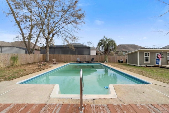 view of swimming pool with an outdoor structure and a deck