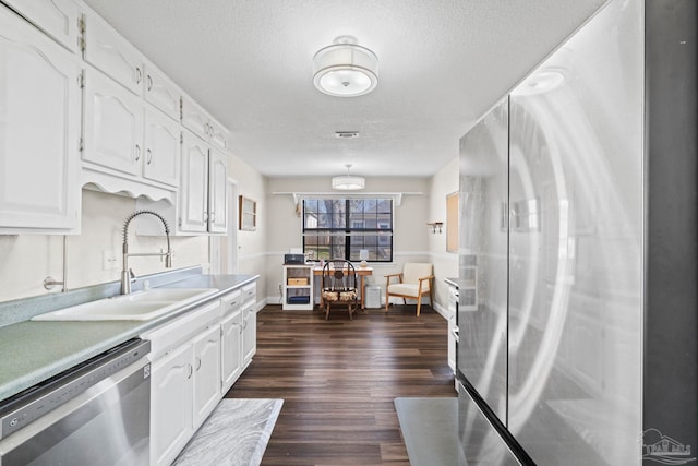 kitchen featuring white cabinetry, appliances with stainless steel finishes, dark hardwood / wood-style floors, and sink