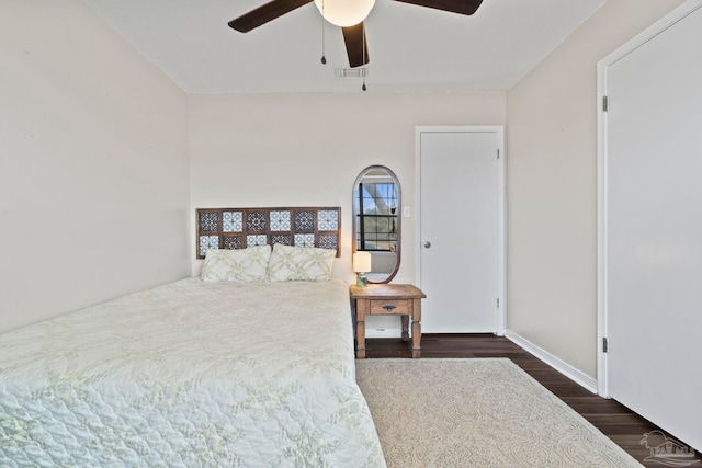 bedroom with dark hardwood / wood-style floors and ceiling fan