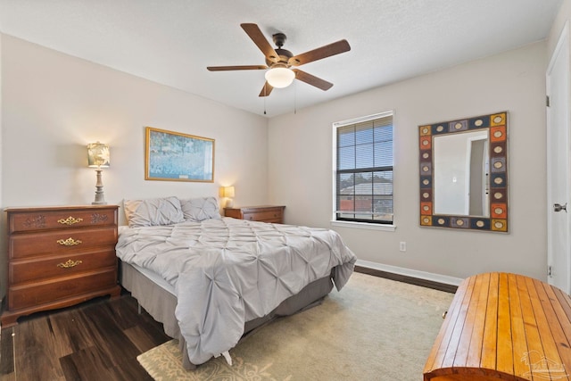 bedroom with dark wood-type flooring and ceiling fan