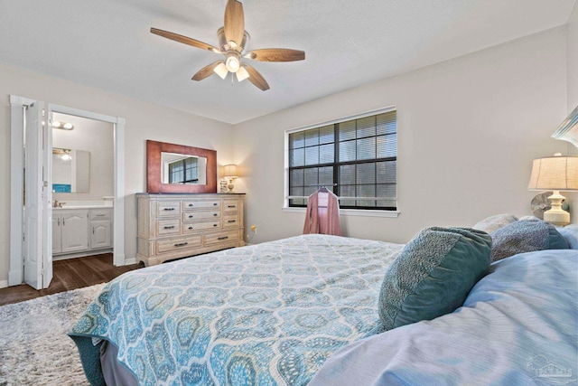 bedroom with ensuite bath, dark wood-type flooring, a textured ceiling, and ceiling fan