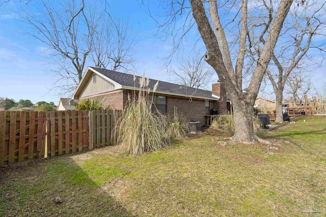 view of home's exterior with a yard and central AC unit