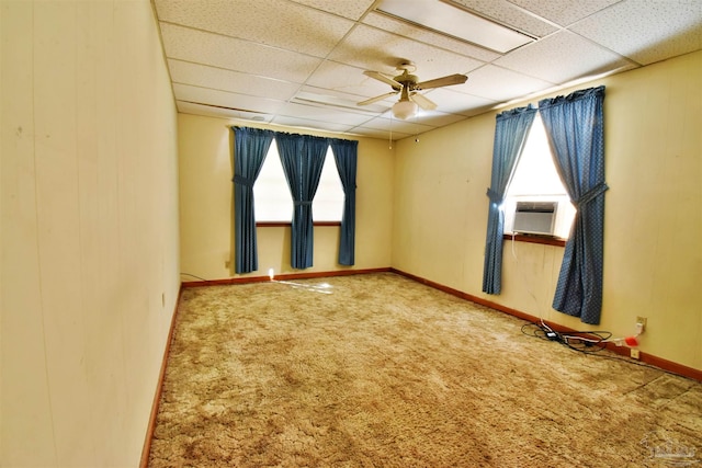 unfurnished room with carpet, ceiling fan, cooling unit, and a drop ceiling