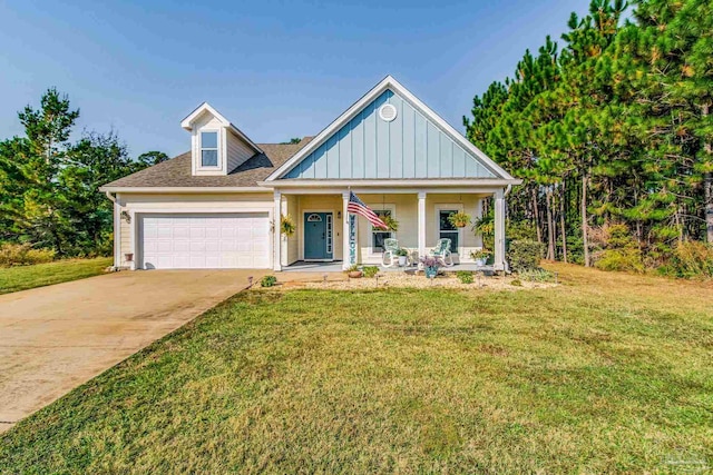 view of front of home featuring a porch, a front yard, and a garage