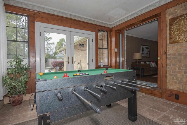 rec room with crown molding, billiards, french doors, and wood walls