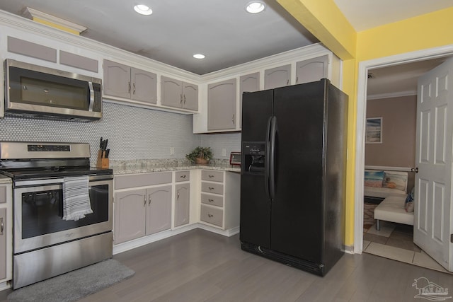 kitchen featuring ornamental molding, appliances with stainless steel finishes, white cabinets, and decorative backsplash