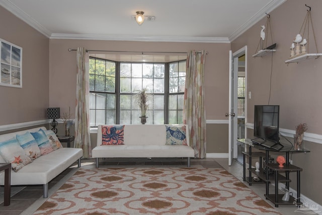 sitting room with tile patterned flooring and crown molding