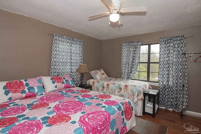 bedroom featuring ceiling fan and dark hardwood / wood-style flooring