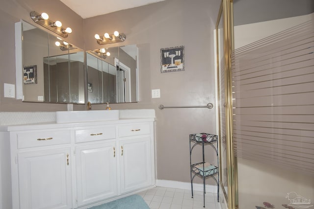 bathroom with tile patterned flooring, vanity, and a shower with door