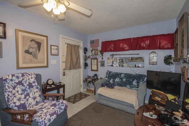 bedroom with light tile patterned floors, a textured ceiling, and ceiling fan