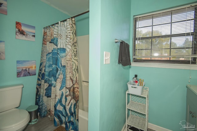 full bathroom featuring shower / bath combination with curtain, vanity, and toilet