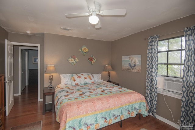 bedroom featuring dark wood-type flooring, ceiling fan, and cooling unit