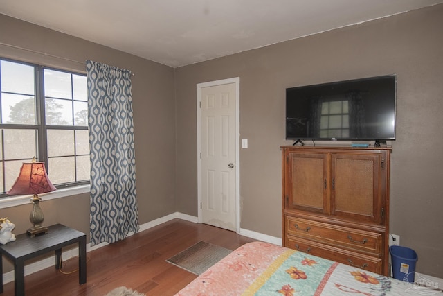 bedroom featuring hardwood / wood-style floors and multiple windows