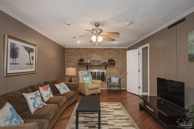 living room featuring ornamental molding, a brick fireplace, ceiling fan, and dark hardwood / wood-style flooring