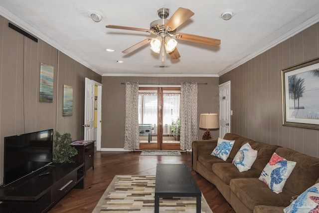 living room with ornamental molding, ceiling fan, and dark hardwood / wood-style flooring