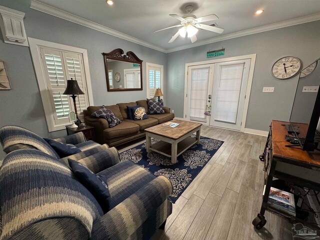 living room with ceiling fan, light wood-type flooring, ornamental molding, and french doors