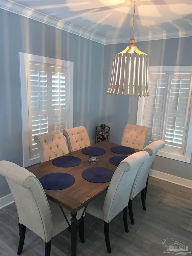 dining room with hardwood / wood-style floors and ornamental molding