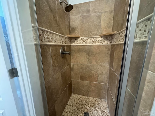 bathroom with a tile shower