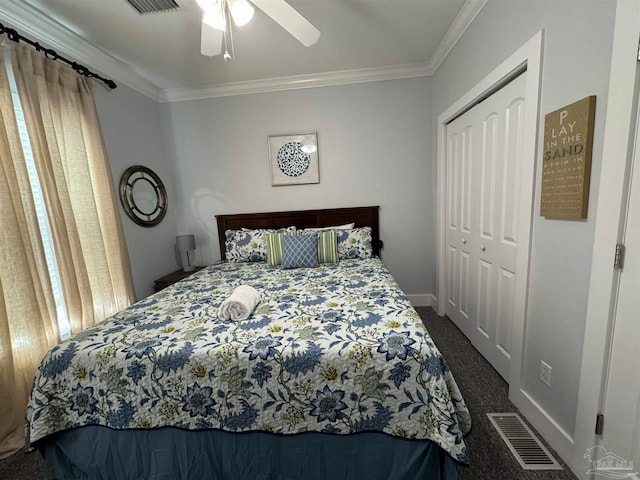 bedroom with dark colored carpet, a closet, crown molding, and ceiling fan