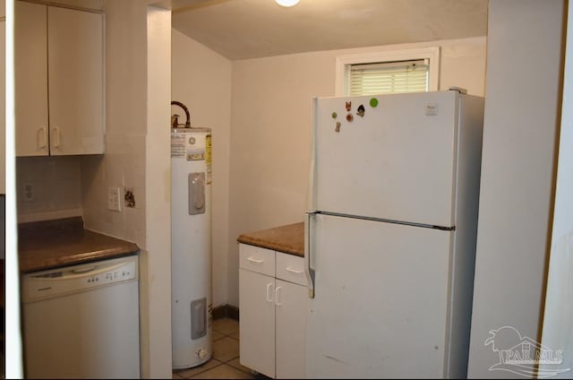 kitchen featuring tasteful backsplash, white appliances, electric water heater, white cabinetry, and light tile patterned flooring