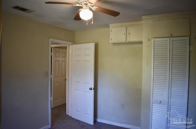 unfurnished bedroom with carpet flooring, ceiling fan, and a closet