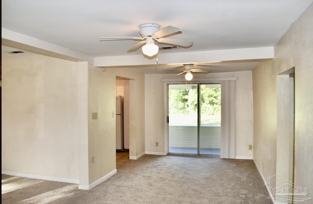 carpeted spare room with ceiling fan